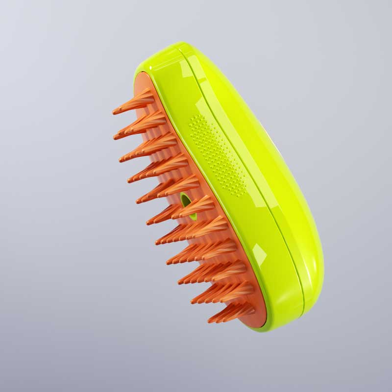 Yellow and orange electric pet brush resting on a gray background